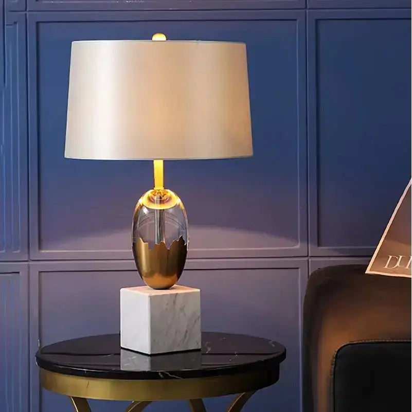 Elegant gold ceramic crystal fabric table lamp with cream satin shade and white marble base for bedroom use