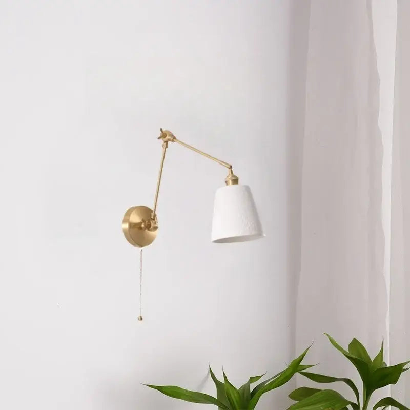 A sleek gold ceramic led wall lamp with brass adjustable arm and white ceramic shade for living room decorbites ceramic led