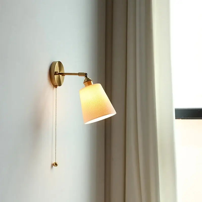 Gold ceramic led wall sconce with ribbed cream fabric shade and adjustable pull-chain switch for bedroom decorbites ceramic led wall