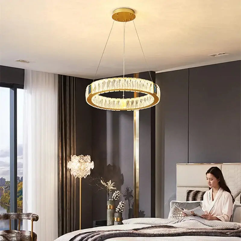 Gold circular decorbites crystal led chandelier with clear crystal accents and gold-toned frame for dining room light
