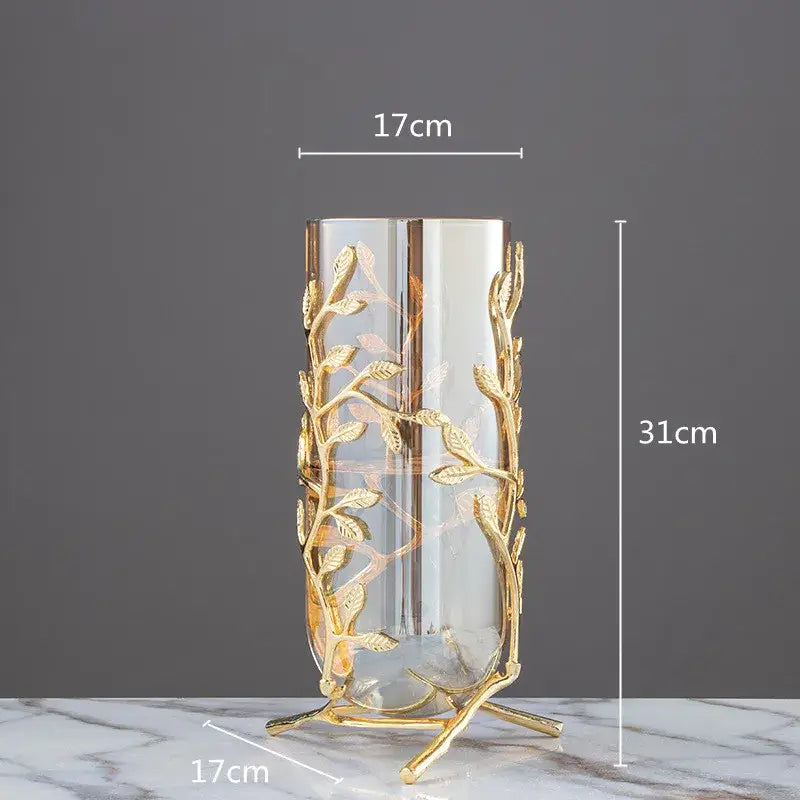 A tall slender glass vase with a gold coral crystal tree metal frame for living room decor