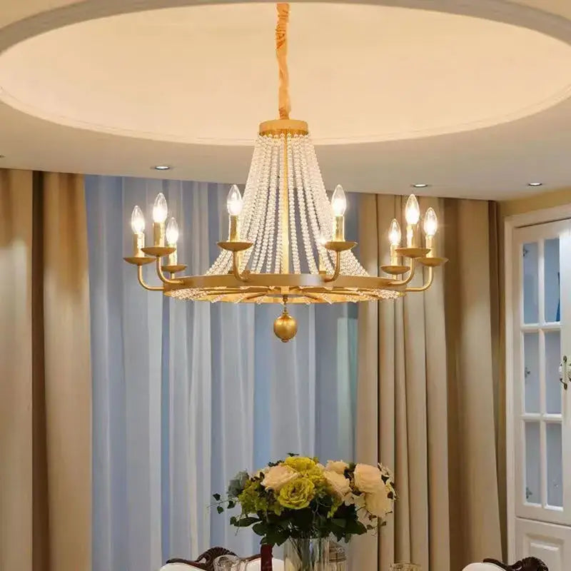 Gold-toned country candle crystal chandelier with cascading beads and lit bulbs for dining room decorbites pendant light