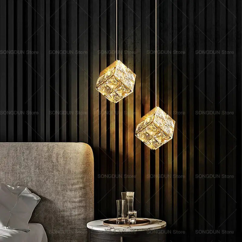 Two gold crystal bedside chandelier pendant lights with cube-shaped crystal and gold-toned metal frames for bedroom decorbites crystal bedside