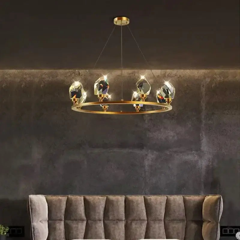 A modern gold-toned dining room chandelier with five faceted crystal pendants by decorbites dining room