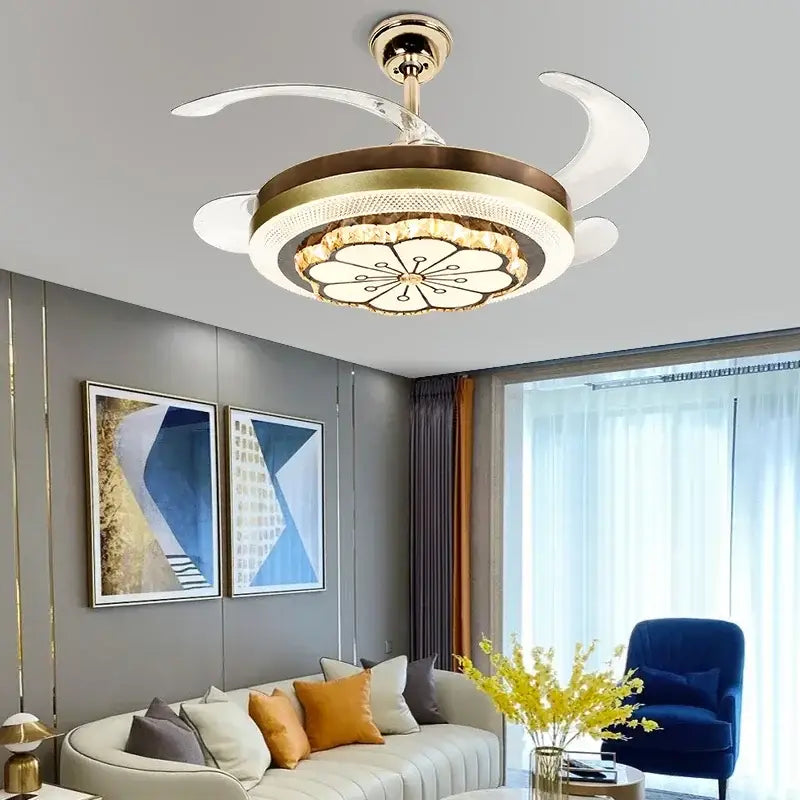 Gold-toned decorbites crystal invisible ceiling fan with integrated lighting and white crescent-shaped blades for living room decor