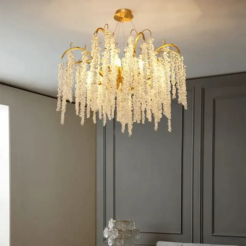 A luxurious gold crystal led chandelier with cascading clear faceted beads for elegant dining room decorbites crystal led