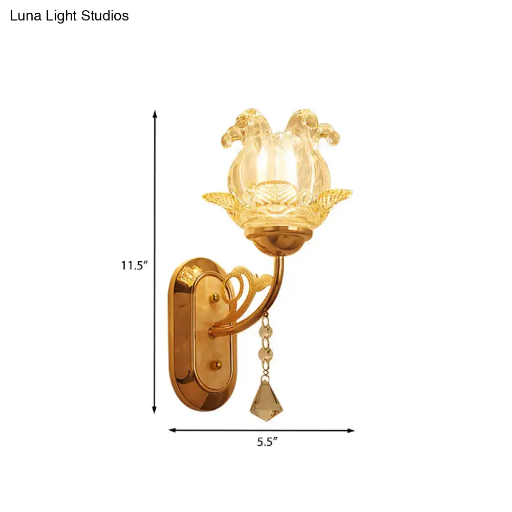 Gold-toned wall lamp with translucent lotus-shaped glass shade and dangling crystals for bedroom simplicity blossom fixture
