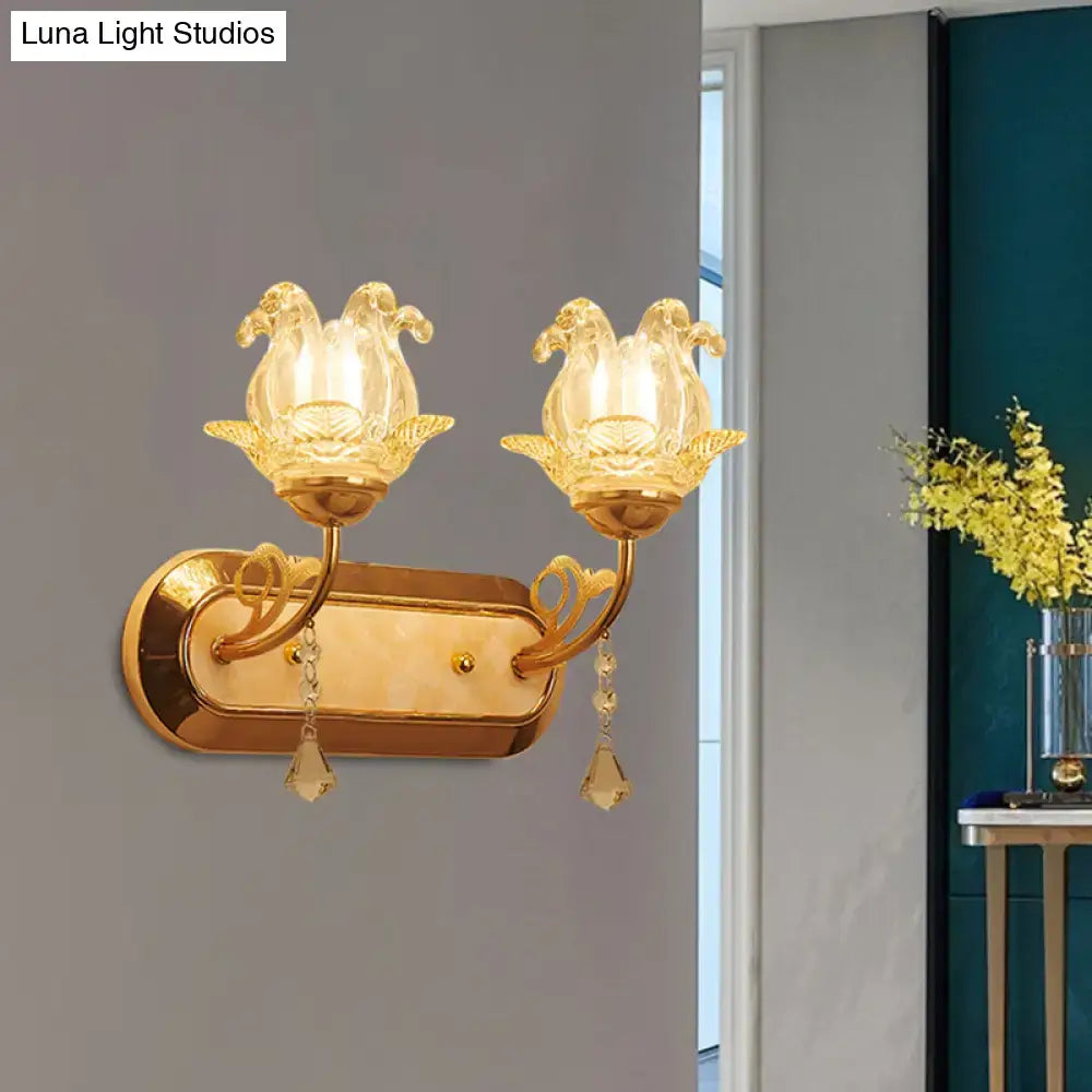 Gold-toned wall lamp with two swan-shaped glass lampshades and crystal teardrops for simplicity blossom fixture width