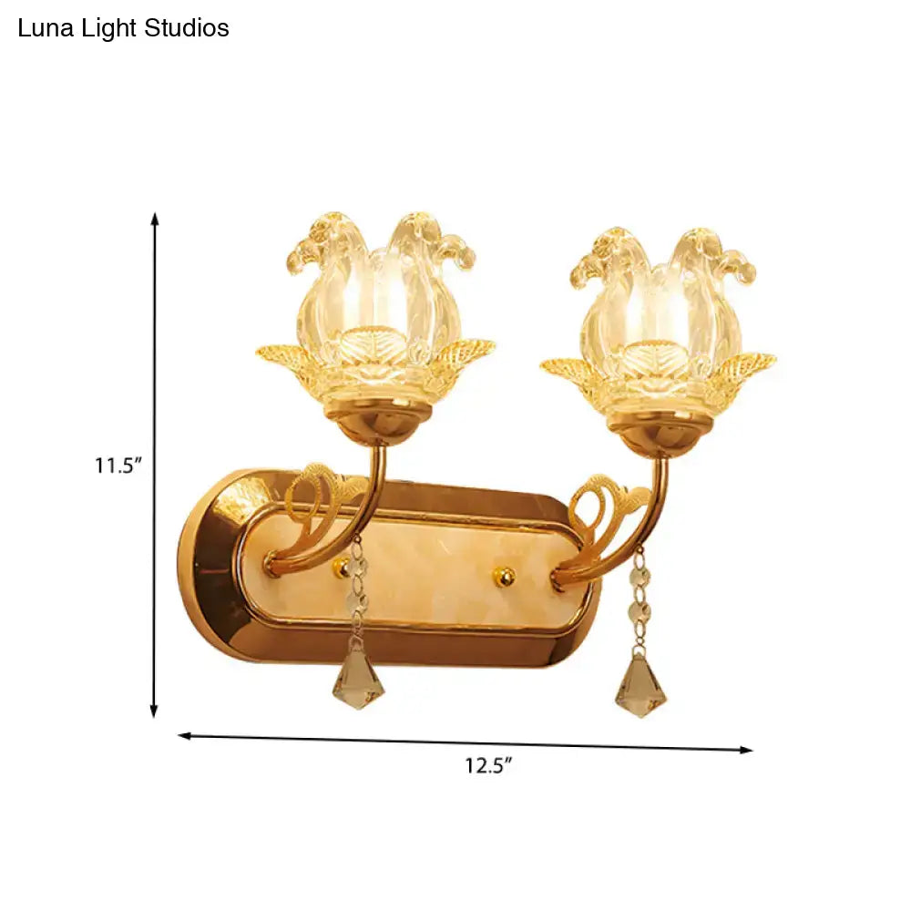 Gold-toned wall lamp with two clear glass lotus shades and crystal pendants for bedroom simplicity blossom fixture