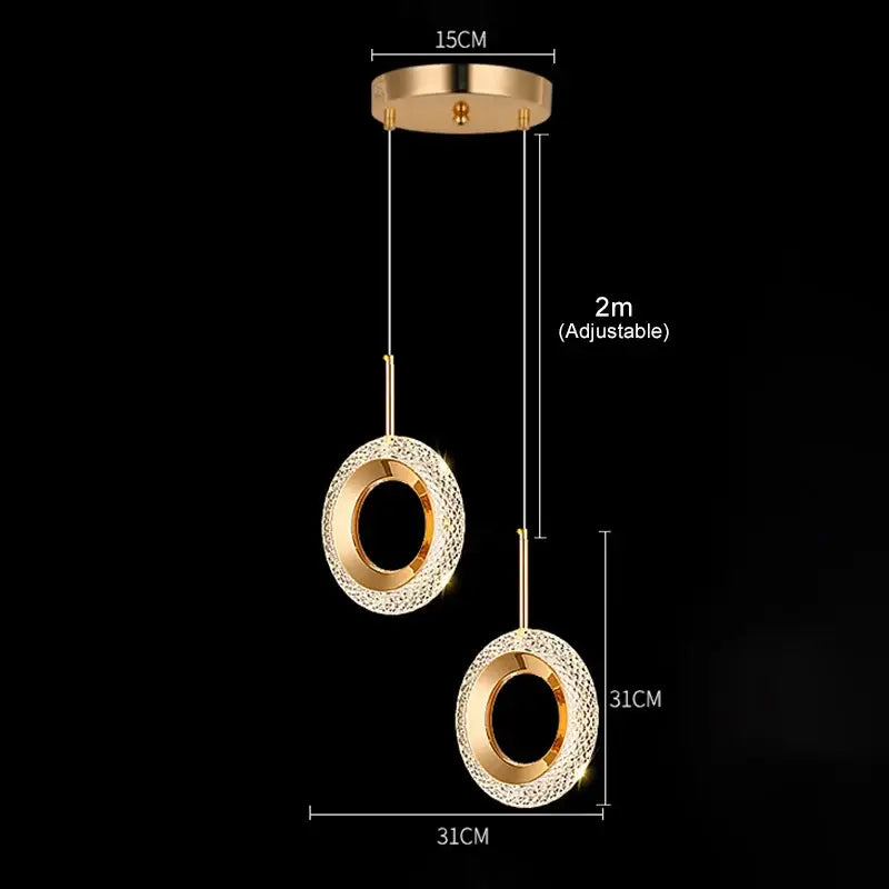 Gold-toned led pendant light with two crystal-encrusted circular shades suspended by adjustable cords for luxury dining room