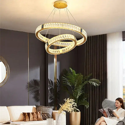 Gold decorbites crystal round ceiling chandelier with gold-toned interlocking rings and clear crystals for dining room use