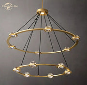 Gold-toned round crystal chandelier with double rings clear crystal spheres and black cords for dining room lighting