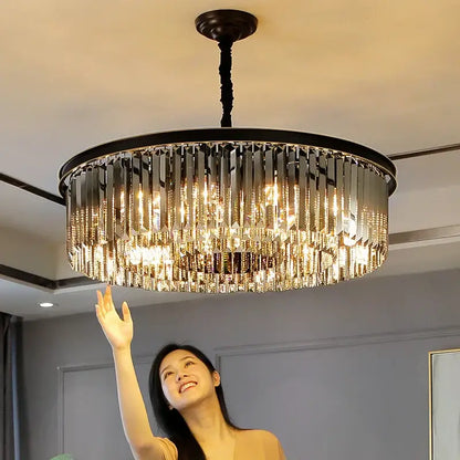 A modern decorbites dual purpose crystal ceiling lamp with a black metal frame and cascading clear faceted prisms