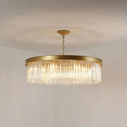 A gold dual purpose crystal ceiling lamp with a modern circular frame and cascading clear crystal prisms by decorbites