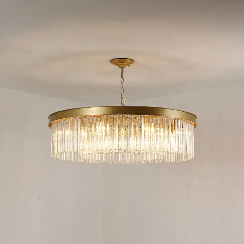 A gold dual purpose crystal ceiling lamp with a modern circular frame and cascading clear crystal prisms by decorbites