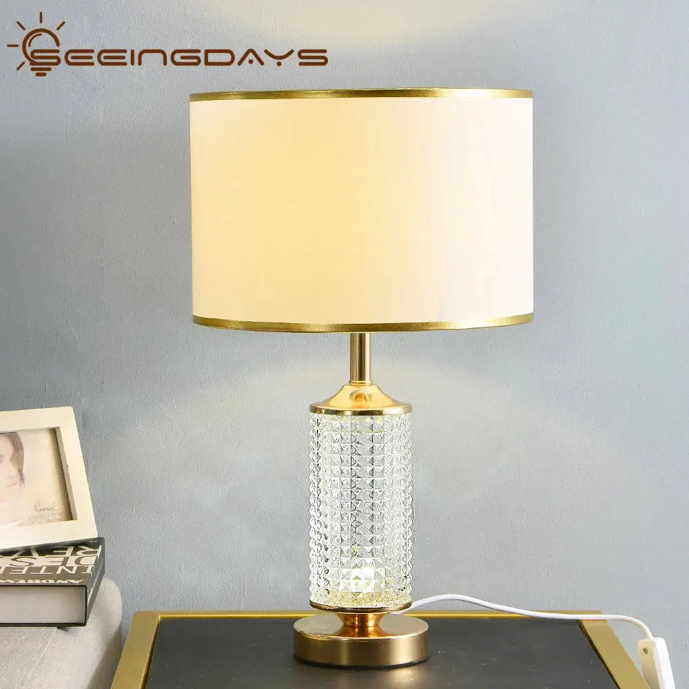 Gold-toned decorbites clear crystal table lamp with faceted clear crystal glass base and off-white fabric shade for bedroom decor