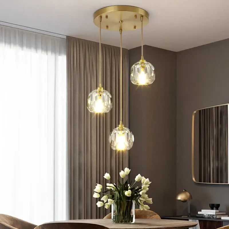 Gold five globe diamond crystal copper led pendant dining room light with gold-toned faceted globe shades hanging from ceiling fixture