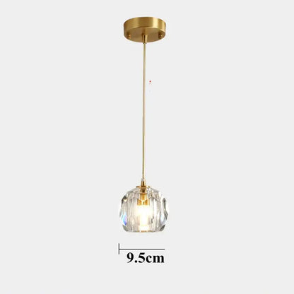 A sleek 9.5cm polished brass copper led pendant light with diamond crystal globe for dining room illumination