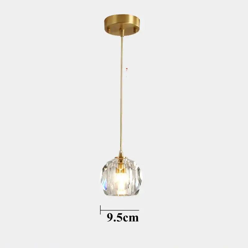 A sleek 9.5cm polished brass copper led pendant light with diamond crystal globe for dining room illumination