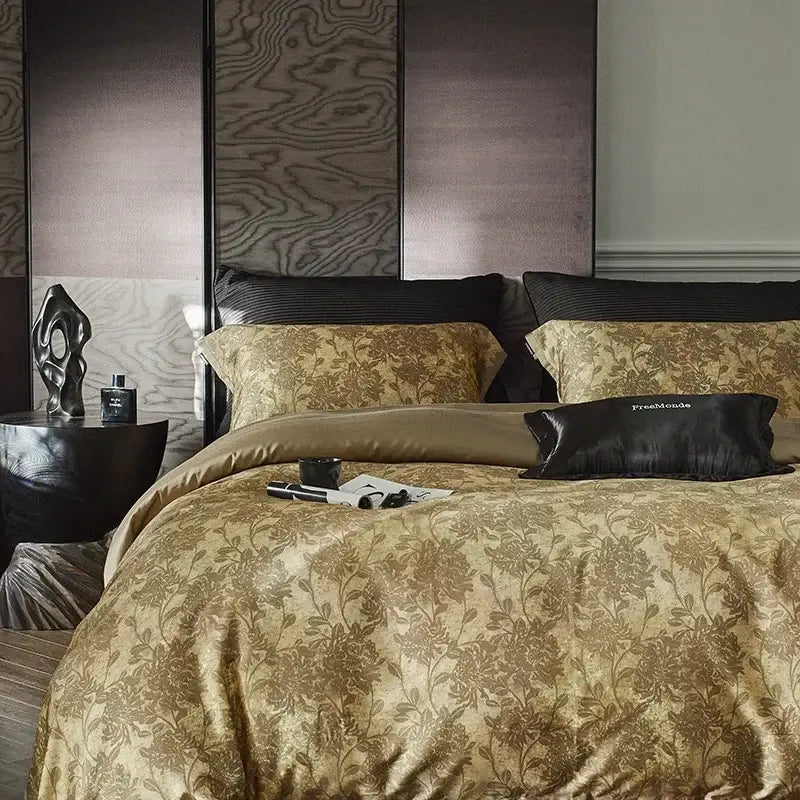 Gold floral satin cotton bedding set featuring a duvet cover with intricate pattern, matching pillow sham, and black silk pillow