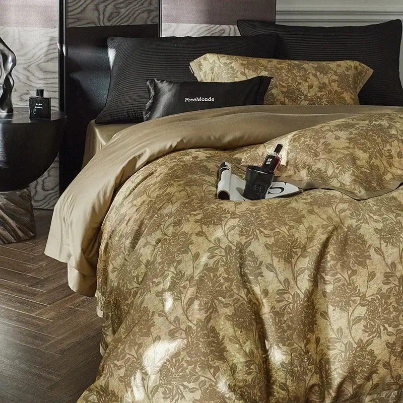 Luxurious gold floral satin cotton bedding set with intricate pattern and matching pillowcases plus black accent pillow