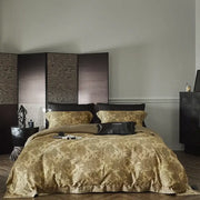 Gold floral satin cotton bedding set featuring a floral pattern with matching pillows and a black accent pillow