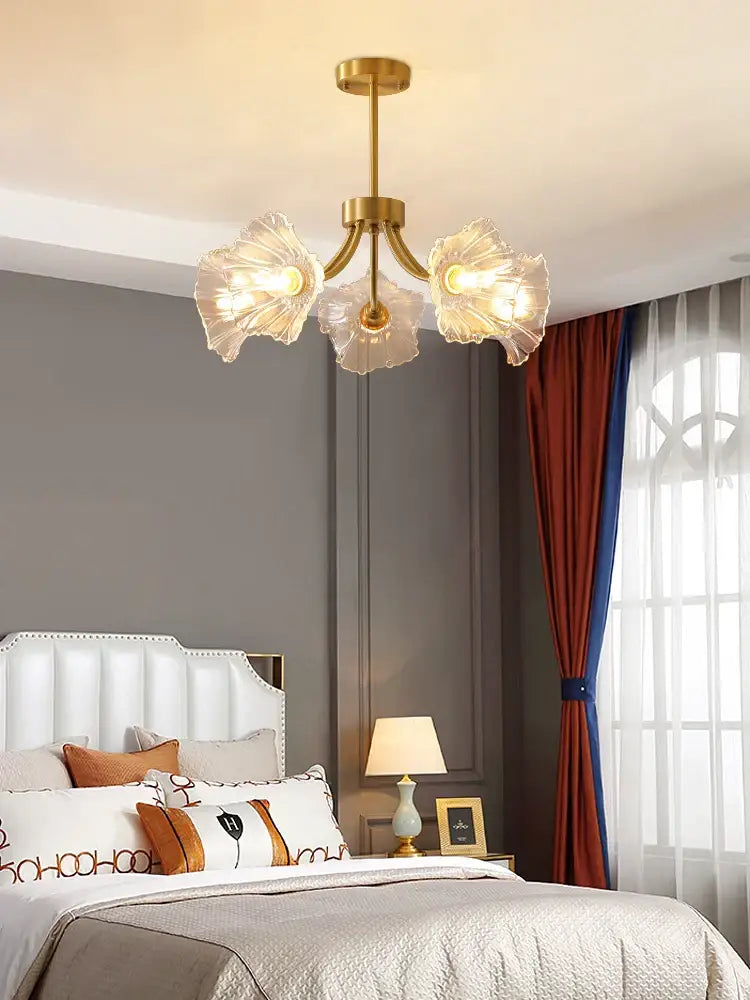 Gold flower chandelier ceiling light with gold tone and translucent glass petals for bedroom use