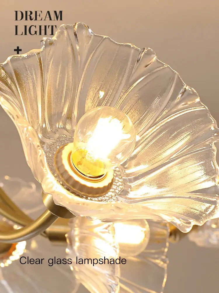 Gold flower chandelier ceiling light featuring a clear glass flower chandelier with petal design and gold metal accents