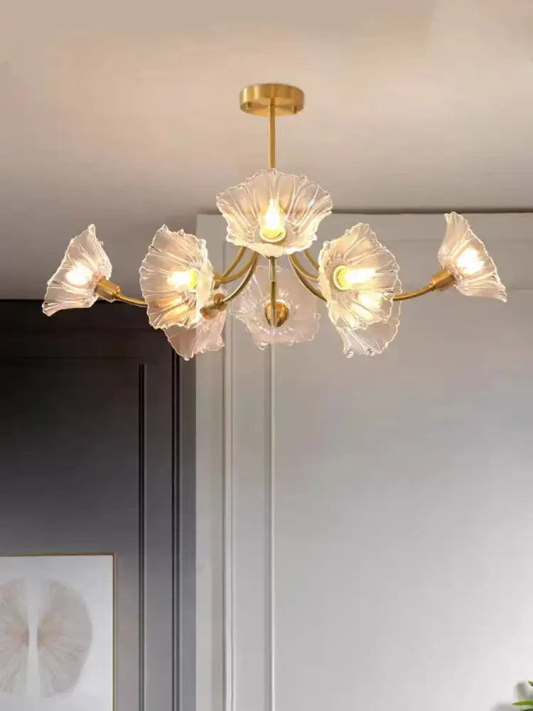 Gold-toned glass flower chandelier ceiling light with five translucent petal-shaped glass shades for bedroom use