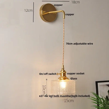 A brass-finished wall light with a textured clear glass led shade and adjustable copper wire by decorbites clear glass