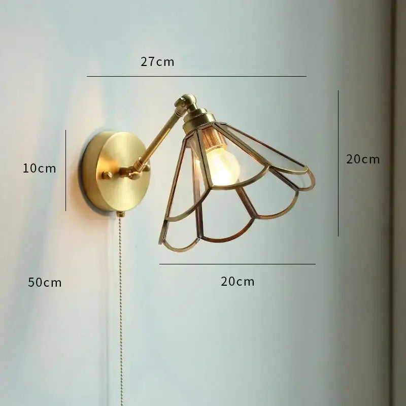 Brass-finished wall sconce with a delicate fan-shaped metal cage and exposed bulb for bedroom wall lamp decorbites copper wall