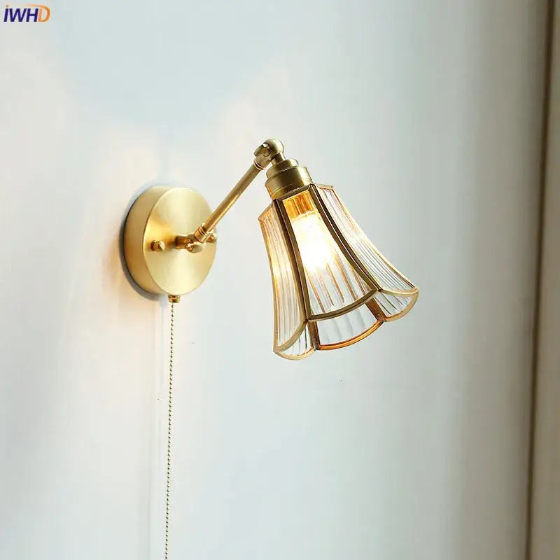Gold-toned wall sconce with fluted glass shade and articulated arm ideal as a bedroom wall lamp decorbites copper wall