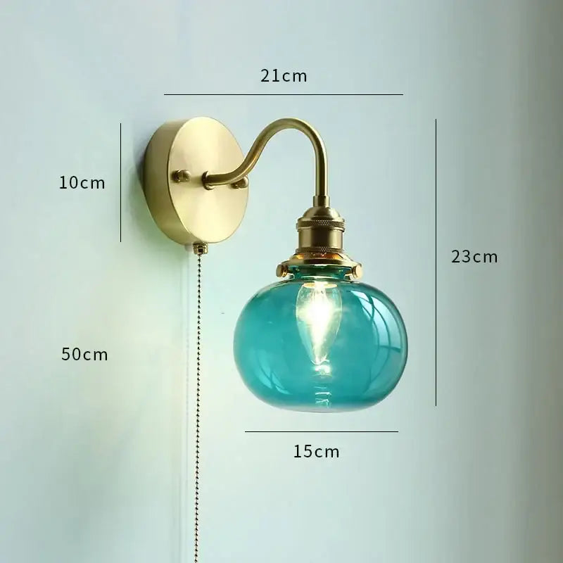 Gold fluted glass wall sconce with brass arm and turquoise globe featuring exposed filament bulb for stylish wall lamp decorbites copper wall