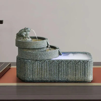 Gray stone fish pond tank fountain with frog figurine flowing water into tiered basins garden ornament