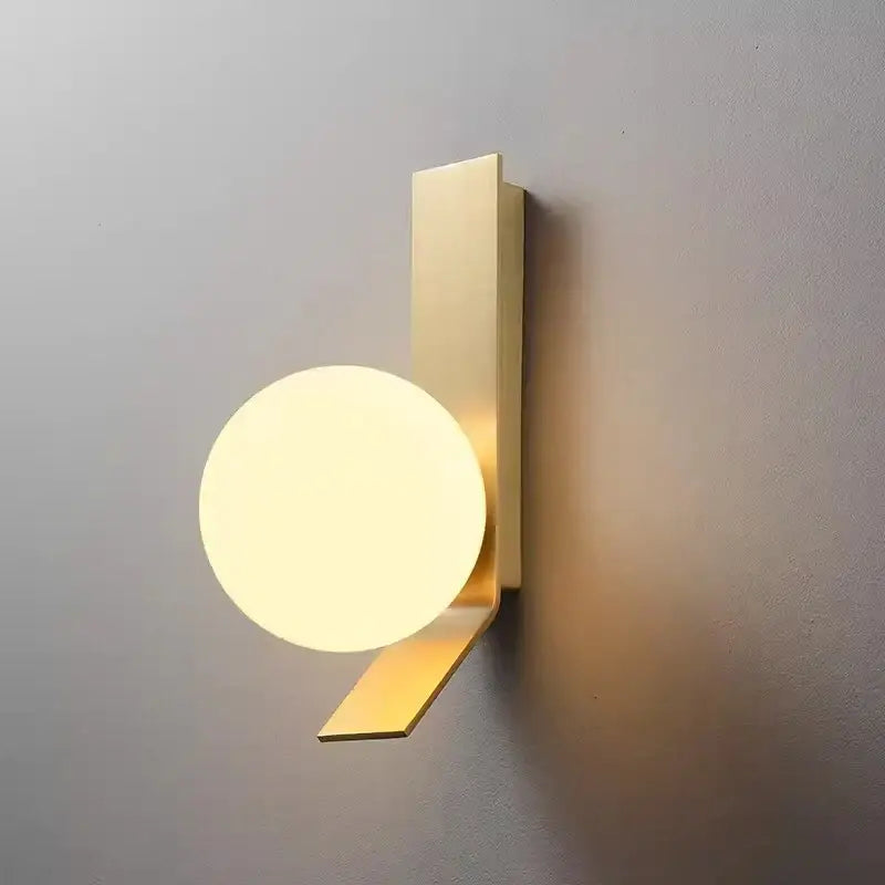 Modern gold-toned wall lamp with a glass ball nordic design featuring a sleek rectangular backplate for decorbites use