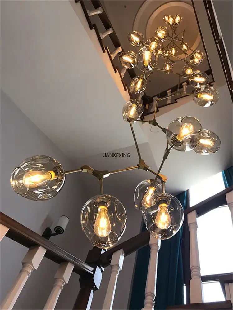 Brass-toned glass branching staircase chandelier with clear globe shades for dining room decorbites glass branching light