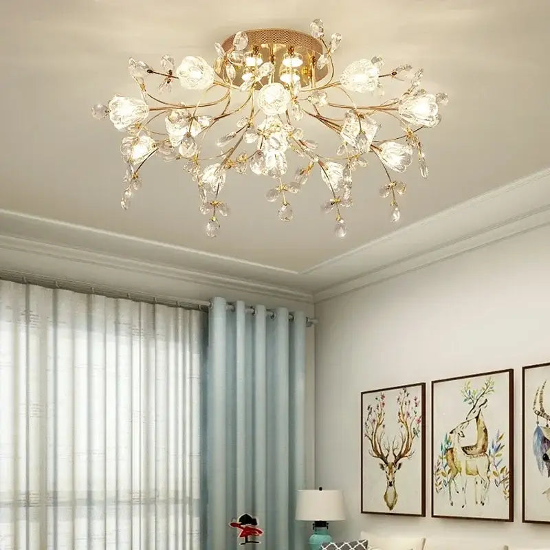 Gold-toned ceiling lamp featuring clear crystal blossoms and droplets in a glass flower chandelier ceiling design for living room
