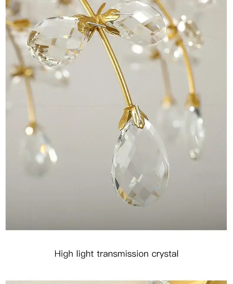 Gold-toned metal arms hold clear teardrop crystals in a glass flower chandelier ceiling lamp for living room use