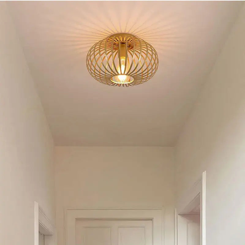 Gold iron art ceiling light with golden woven wireframe design emitting a warm glow for living room decorbites iron art