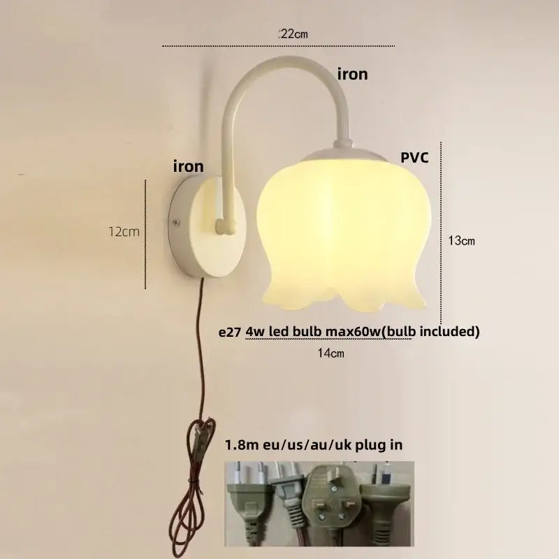 A soft yellow tulip-shaped iron led wall sconce with white iron base and curved arm for hallway decorbites iron led lighting