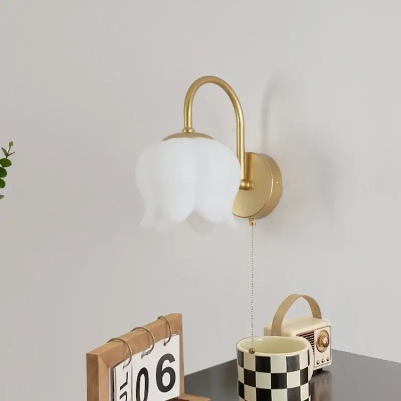 Gold iron led wall sconce with pull chain featuring a frosted white tulip glass shade for hallway decorbites iron led wall
