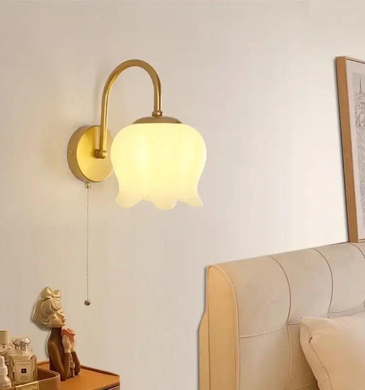 Gold iron led wall sconce decorbites with pull chain featuring a gold-toned iron frame and frosted glass tulip shade for hallway