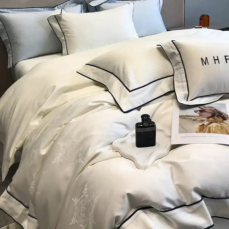 Cream-colored satin bedding set with subtle floral embroidery and black piping in decorbites jacquard satin egyptian cotton patchwork