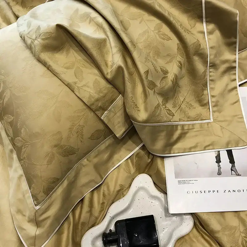 Gold-toned satin pillowcase with subtle leaf embroidery and white piping in decorbites jacquard satin egyptian cotton patchwork bedding set