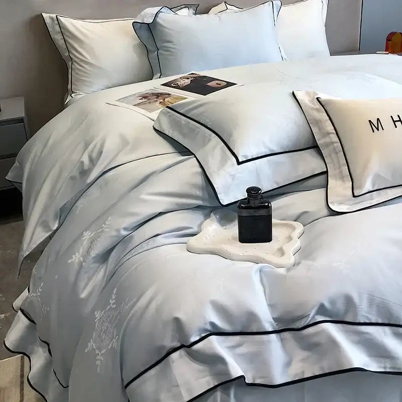 Light blue satin bedding set with black piping and floral embroidery in decorbites jacquard satin egyptian cotton patchwork style