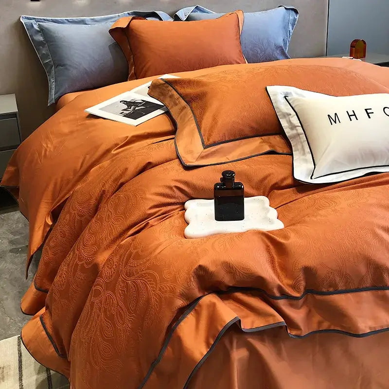 Orange satin bedding set with subtle paisley embroidery and dark gray piping in decorbites jacquard satin and egyptian cotton patchwork