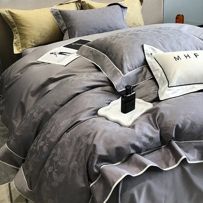 Gray satin-like bedding set with subtle leaf embroidery and white piping in decorbites jacquard satin and egyptian cotton patchwork