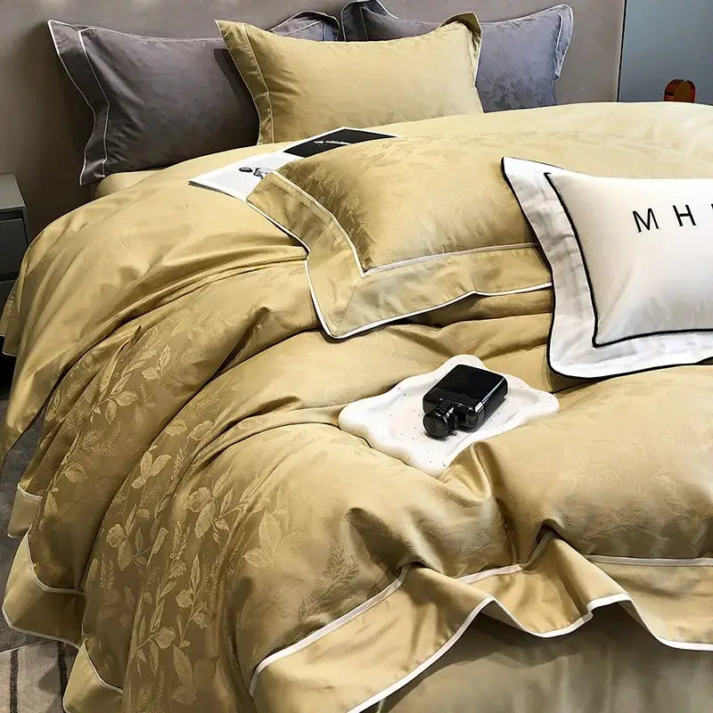Gold-toned decorbites jacquard satin bedding set with subtle floral embroidery and crisp white piping in egyptian cotton patchwork