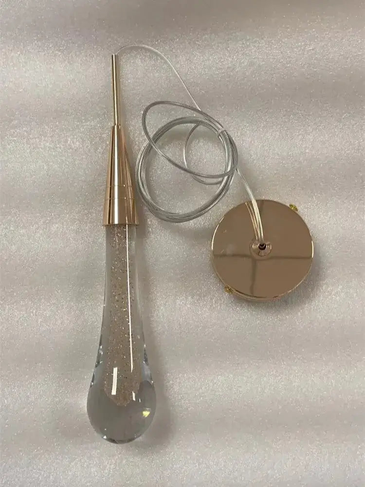 Gold liquid crystal drop pendant light with gold metal top and embedded glitter decorbites crystal drop pendant