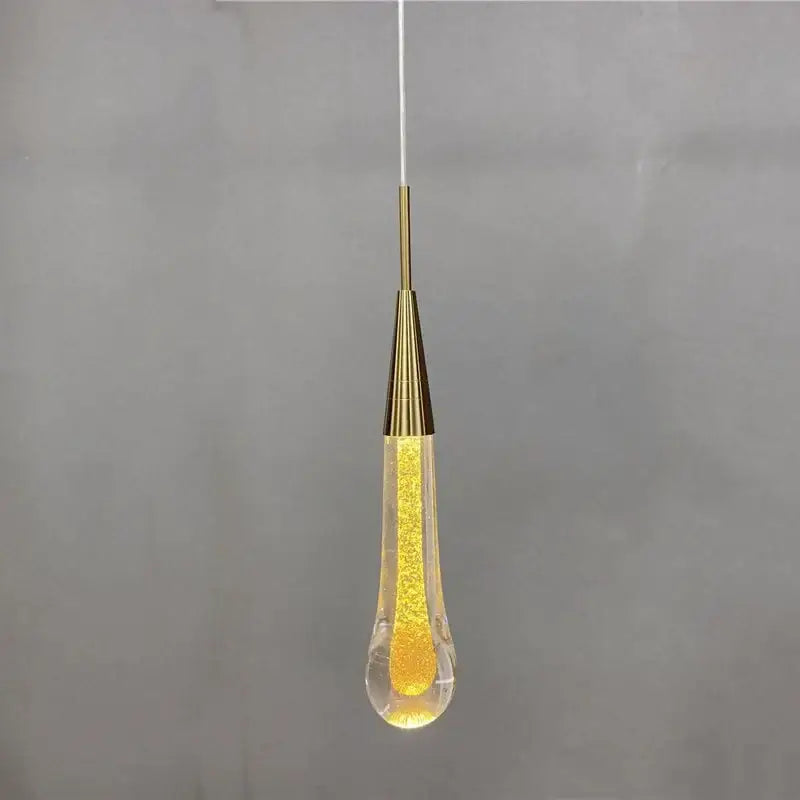 Gold liquid crystal drop pendant light featuring a clear glass teardrop with glowing beads for elegant decorbites crystal drop decor